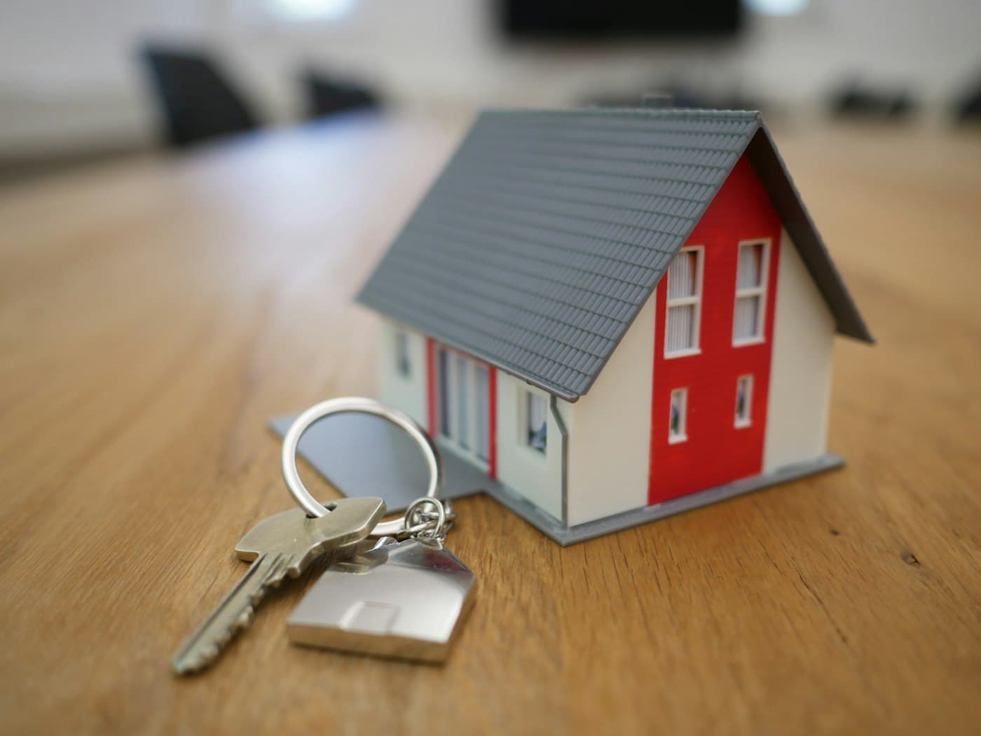 House keys and model home representing rental property